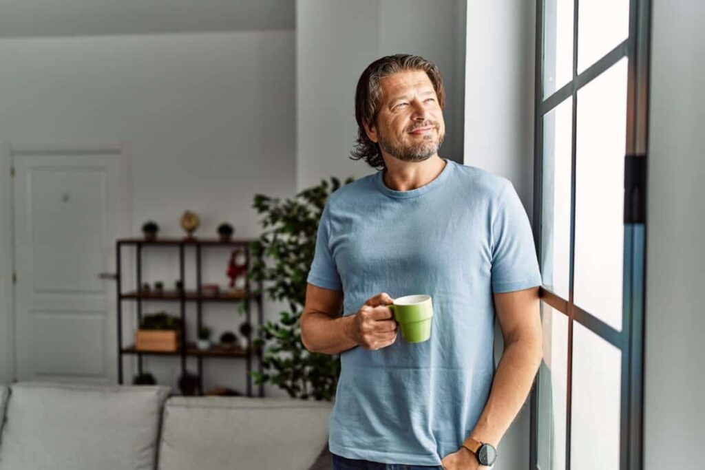 3 Dividend Stocks to Comfortably Hold for the Next 5 Years Middle aged man drinks coffee
